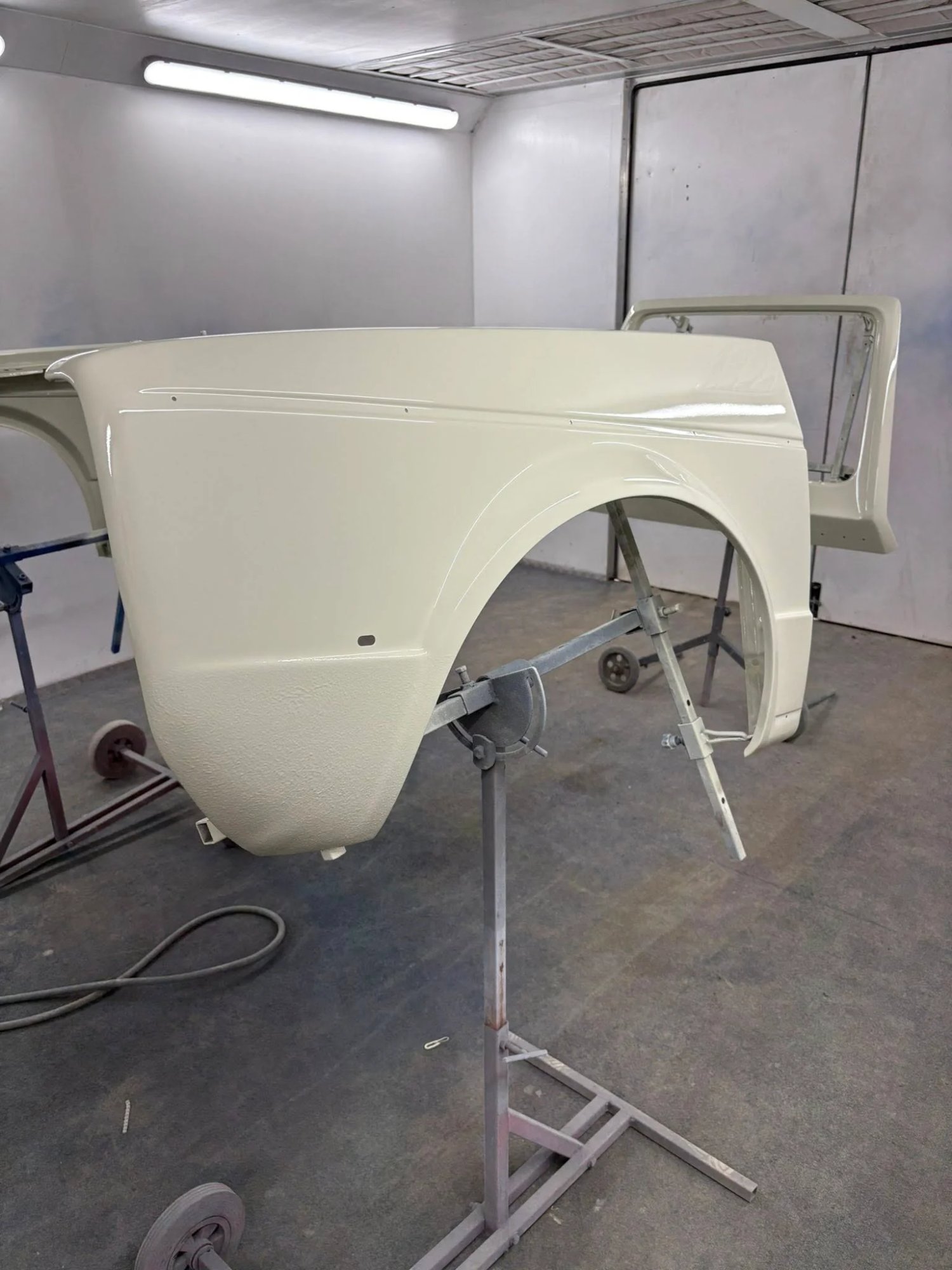 Freshly painted vehicle panel in professional spray booth at Ant Fabrications automotive body shop, Wardington, near Banbury, Oxfordshire